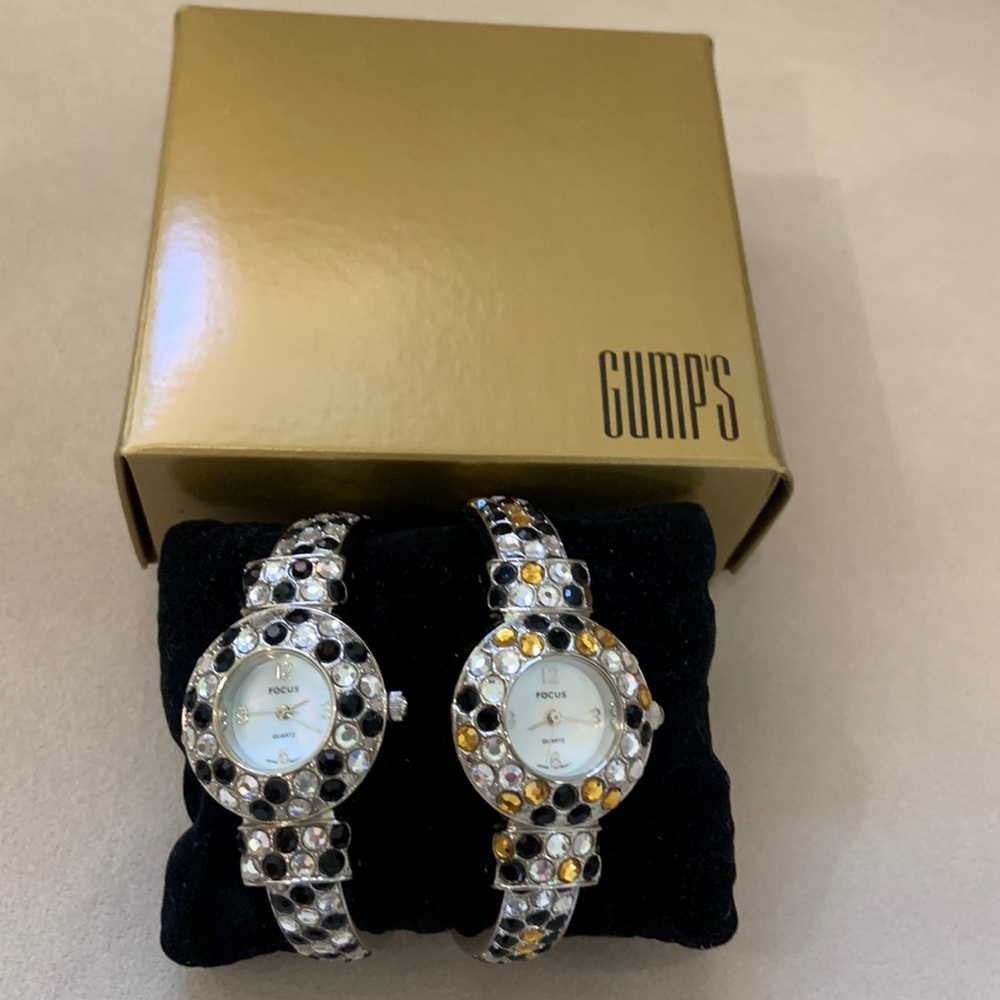 2 fashion rhinestone  bracelet watches.  Focus is the brand.